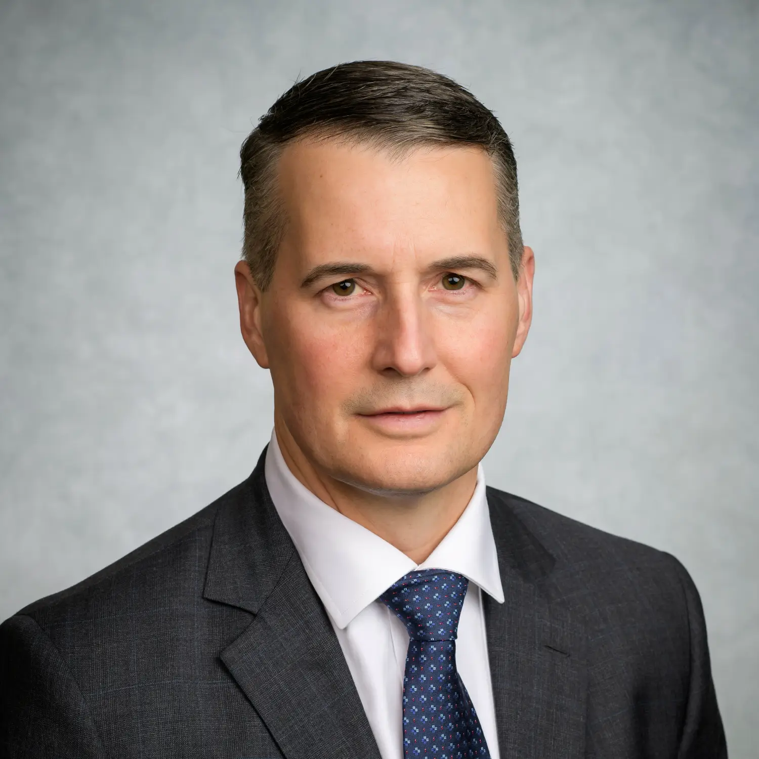 Doctor Kevin Barlotta; a middle-aged man in a suit and tie.